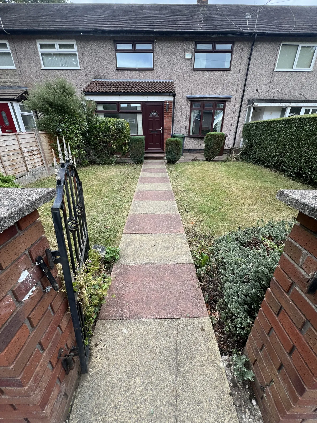 After: the same front path with borders cut back and the lawn tidied