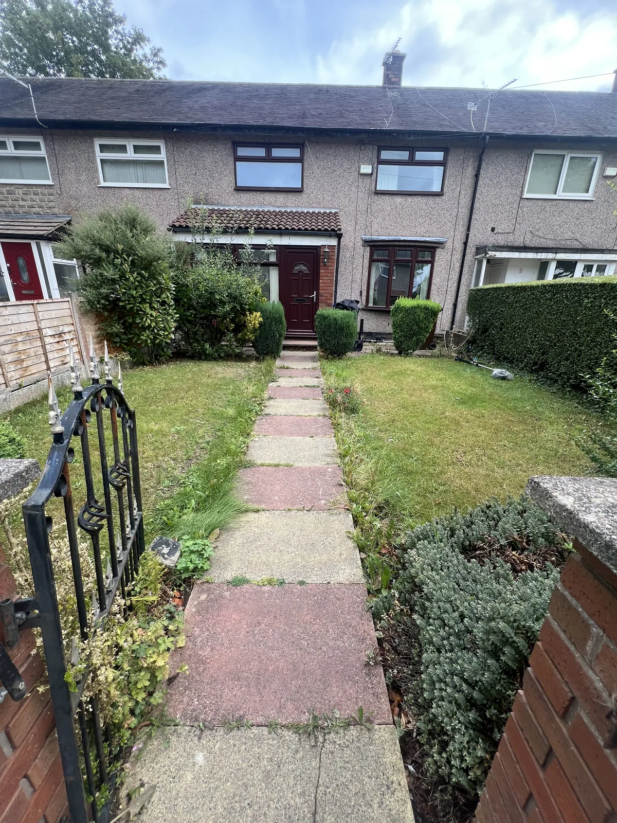Before: overgrown borders and a lawn with weeds either side of a paved front path